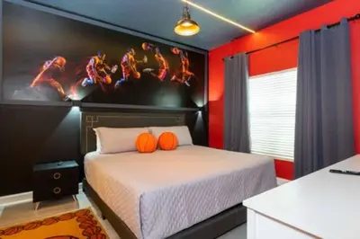 a bedroom with a bed with orange pillows on it at 4 Bedrooms3 Bathrooms at Storey Lake Resort in Kissimmee