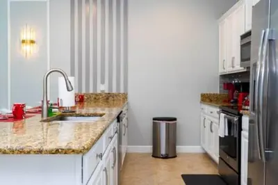 a white kitchen with a sink and a refrigerator at 4 Bedrooms3 Bathrooms at Storey Lake Resort in Kissimmee