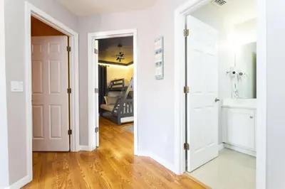 an open door into a room with a hallway with a staircase at Beautiful 4 Bedroom Pool Home Near Disney in Kissimmee