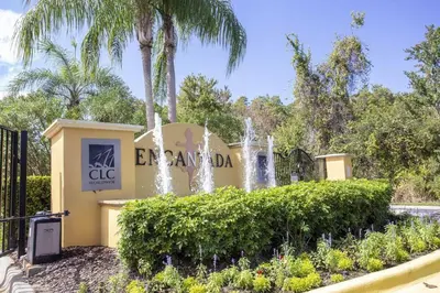 a sign for the entrance to the encantada club with a fountain at Beautiful 4 Bedroom Pool Home Near Disney in Kissimmee