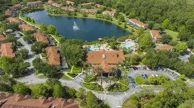 an aerial view of a house with a lake at Beautiful 4 Bedroom Pool Home Near Disney in Kissimmee
