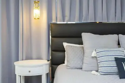 a bedroom with a bed and a nightstand next to a bed with a bed at Beautiful 4 Bedroom Pool Home Near Disney in Kissimmee