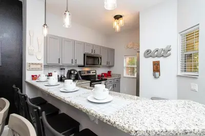 a kitchen with white cabinets and a counter top at 3 Bedrooms Home W Pool just 6 miles from Disney in Kissimmee