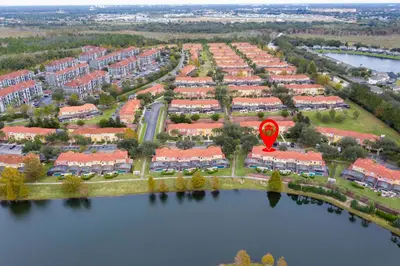 an aerial view of aominium complex with a red marker at 3 Bedrooms Home W Pool just 6 miles from Disney in Kissimmee