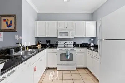 a kitchen with white cabinets and a white refrigerator at Perfect Gateway to Disney 9108 in Kissimmee