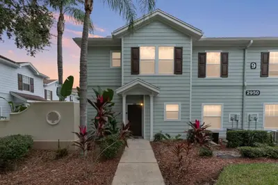 a house with palm trees in front of it at Perfect Gateway to Disney 9108 in Kissimmee