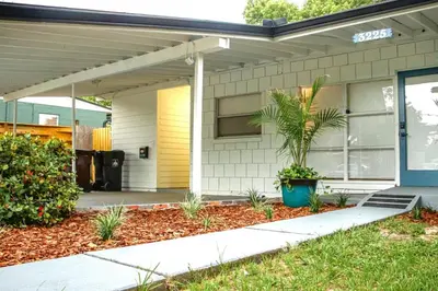 a house with a palm tree in the front yard at Exquisite Luxury Villa with Pool in Prime Location in Orlando