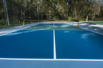 a tennis court with a net on top of it at Modern 1BED 1BA Gem in Great Location Free Parking in Kissimmee