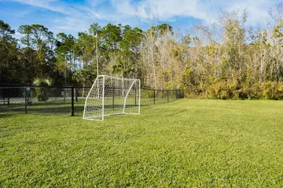 a soccer goal in the middle of a field at Modern 1BED 1BA Gem in Great Location Free Parking in Kissimmee
