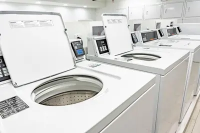 a white washing machine in a white room at Modern 1BED 1BA Gem in Great Location Free Parking in Kissimmee