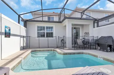 a swimming pool in the backyard of a house at Your 5BDR house with pool - 4959 in Kissimmee