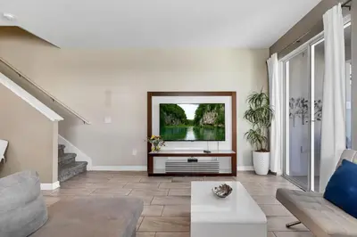 a living room with a tv and a couch at Your 5BDR house with pool - 4959 in Kissimmee