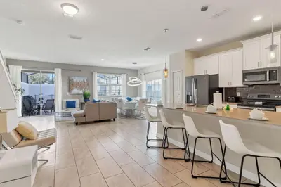 a kitchen and living room with a table and chairs at Your 5BDR house with pool - 4959 in Kissimmee