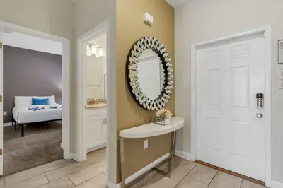 a bathroom with a mirror and a sink and a bed at Amazing 4BDR with pool near Disney - 4914 in Kissimmee