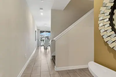 a hallway with white walls and a staircase at Amazing 4BDR with pool near Disney - 4914 in Kissimmee