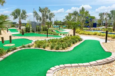 a golf course with green grass and palm trees at Amazing 4BDR with pool near Disney - 4914 in Kissimmee