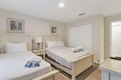 a bedroom with two beds and a desk with a laptop at Your 4BDR Vacation Home - 4838 in Kissimmee