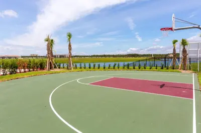 a basketball court with a hoop and palm trees at Your 4BDR Vacation Home - 4838 in Kissimmee