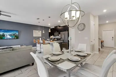 a dining room and living room with a table and chairs at Your 4BDR Vacation Home - 4838 in Kissimmee