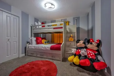 a childs bedroom with a mickey mouse bunk bed at Casa Temática c/ Piscina no Storey Lake in Kissimmee