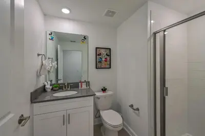 a bathroom with a toilet and a sink and a shower at Casa Temática c/ Piscina no Storey Lake in Kissimmee