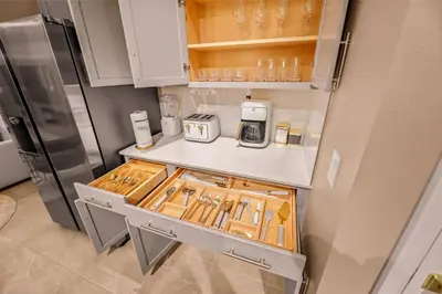 a kitchen with a counter and a refrigerator at Luxury Stay Walk to SeaWorld Minions Room in Orlando