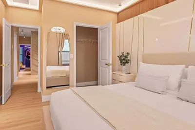 a bedroom with a white bed and a mirror at Luxury Stay Walk to SeaWorld Minions Room in Orlando