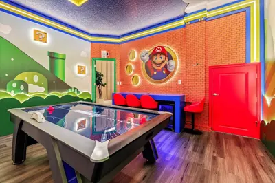 a room with a ping pong table in the middle at Luxury Stay Walk to SeaWorld Minions Room in Orlando