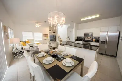a kitchen and dining room with a table and chairs at Villa Bella - 4 Bedrooms in Kissimmee