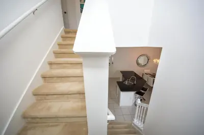 a staircase in a home with white walls and floors at Villa Bella - 4 Bedrooms in Kissimmee