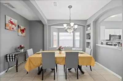 a dining room with a yellow table and chairs at Family Fun Kissimmee Retreat in Kissimmee