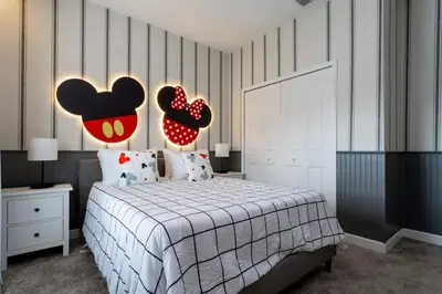 a bedroom with a bed with a mickey mouse headboard at Casa 5 Quartos com Piscina e Tema Disney in Kissimmee