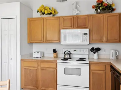 a kitchen with a white stove and a microwave at Sunny Getaway with Private Pool, Spa & Fenced Yard in Kissimmee
