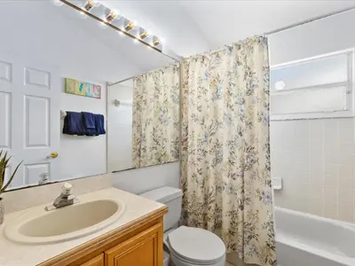 a bathroom with a sink and a toilet and a shower at Sunny Getaway with Private Pool, Spa & Fenced Yard in Kissimmee
