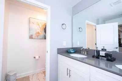 a bathroom with two sinks and a mirror at Magical Stay Mickey and Harry Potter Rooms in Kissimmee