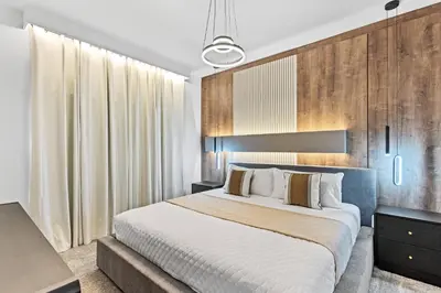 a bedroom with a large bed and wooden walls at New Home 04 Bedrooms At Storey Lake in Kissimmee