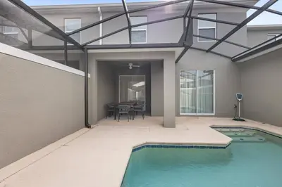 a house with a swimming pool with a glass roof at New Home 04 Bedrooms At Storey Lake in Kissimmee