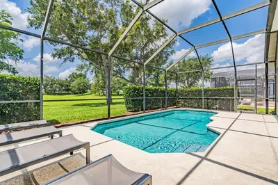 an image of a swimming pool in a glass house at 5BR Kissimmee Home Pool and Game Room Fun in Kissimmee