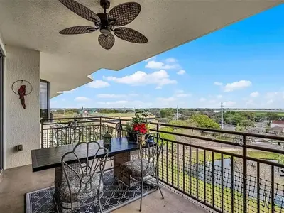 a balcony with a table and chairs and a ceiling fan at Spacious Lakefront Condo in Kissimmee in Kissimmee