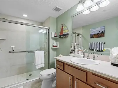 a bathroom with a shower and a toilet and a sink at Spacious Lakefront Condo in Kissimmee in Kissimmee