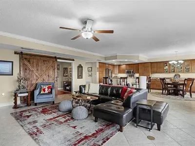 a living room with a couch and a ceiling fan at Spacious Lakefront Condo in Kissimmee in Kissimmee