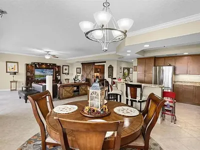 a kitchen and living room with a table and chairs at Spacious Lakefront Condo in Kissimmee in Kissimmee