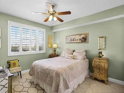 a bedroom with a bed and a ceiling fan at Spacious Lakefront Condo in Kissimmee in Kissimmee