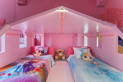 two beds in a pink room with two teddy bears at 2817 Storey Lake Kissimmee in Kissimmee