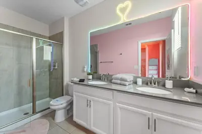 a bathroom with two sinks and a shower and a toilet at 2817 Storey Lake Kissimmee in Kissimmee