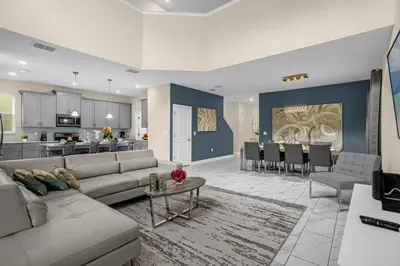 a large living room with a couch and a kitchen at Disney Vacation Villa Pool & BBQ & Resort Clubhouse in Kissimmee