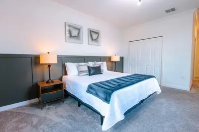 a bedroom with a large bed and two lamps at Fantasy Stay in 5 bed at Storey Lake in Kissimmee