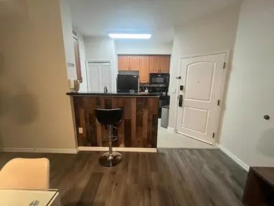 an empty living room with a counter and a kitchen at Universal-Disney Dream 606S - 1 Bedroom in Orlando