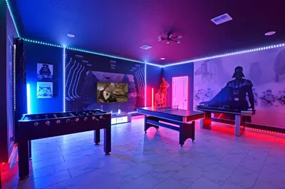 a room with two ping pong tables and purple lights at 4213 - Lakeside Retreat in Kissimmee