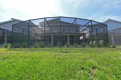 a large glass building with a lawn in front of it at 2956 - Sanctuary at Storey Lake in Kissimmee